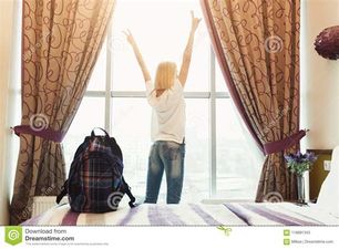 girl standing near window